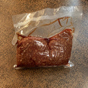 Sealed ground meat package on counter