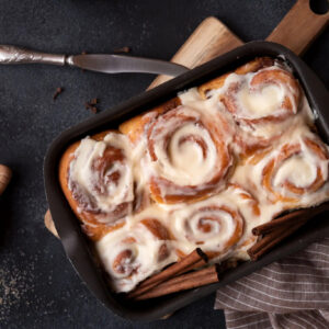 Iced cinnamon rolls in baking dish