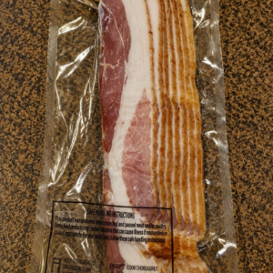 Packaged bacon on a brown countertop