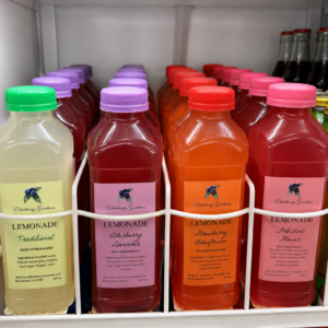 Assorted bottled lemonades on a refrigerator shelf