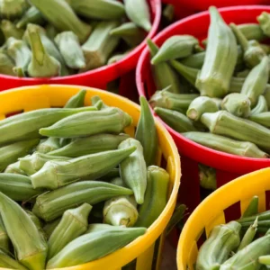 Fresh okra in colorful market baskets