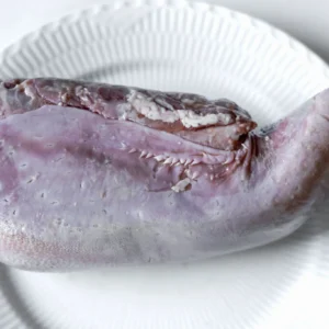 Raw beef tongue on white plate