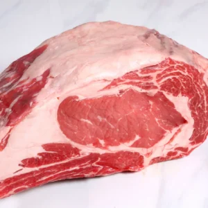 Raw beef ribeye roast with fat cap
