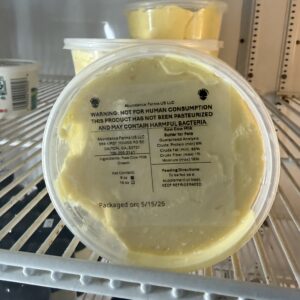 Tubs of yellow spread with warning label