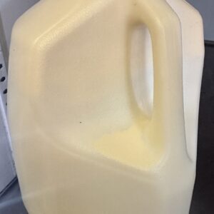 Plastic gallon milk jug with red cap