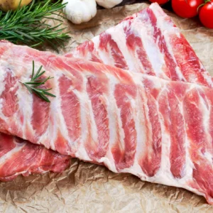 Raw pork ribs with rosemary and tomatoes