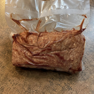 Vacuum-sealed ground meat package