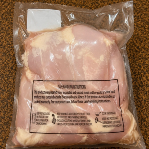 Vacuum-sealed chicken on brown surface
