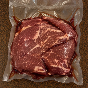 Marbled steak in sealed plastic bag