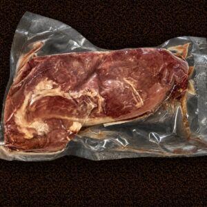 Packaged steak in vacuum-sealed bag