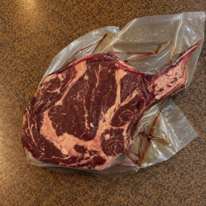 Fresh tomahawk steak on countertop