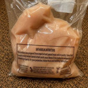 Sealed bag of uncooked chicken pieces