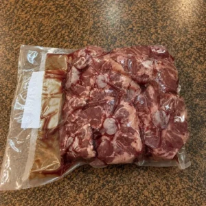 Packaged raw meat on brown countertop