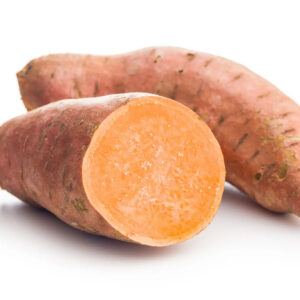 Two sweet potatoes, one cut, white background