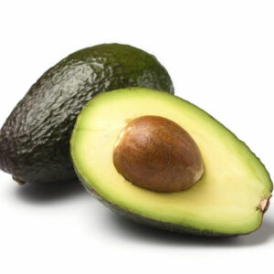 Ripe avocado, whole and halved with pit